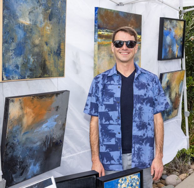 Lucas Smith with his paintings. (Milan Kovacevic)