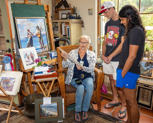 Dot Renshaw showing her artwork to Michael Trogdon and Surabhi...