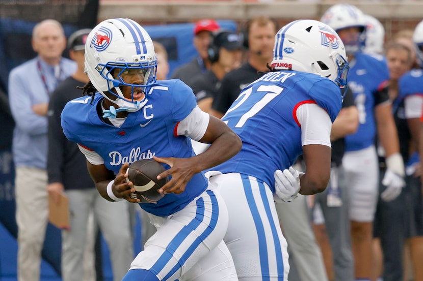 SMU quarterback Kevin Jennings (7) looks to throw the ball during the first half of an NCAA...