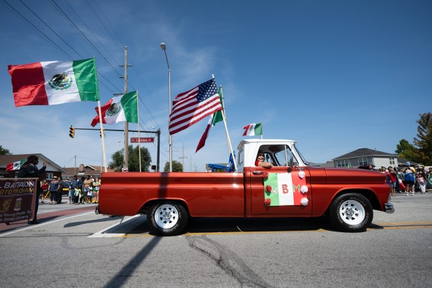 A vintage truck flying United States and Mexican Flags cruises down Columbus Drive during the Fiestas Patrias Parade in East Chicago on Sunday, Sept. 15, 2024. (Kyle Telechan/for the Post-Tribune)