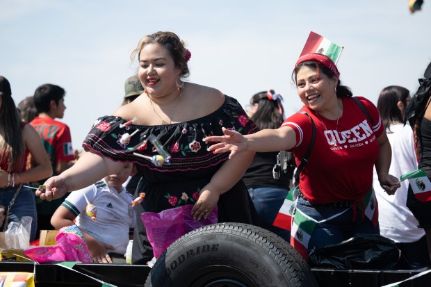 East Chicago Central Spanish Club volunteers and participants throw candy from a float during the Fiestas Patrias Parade in East Chicago on Sunday, Sept. 15, 2024. (Kyle Telechan/for the Post-Tribune)