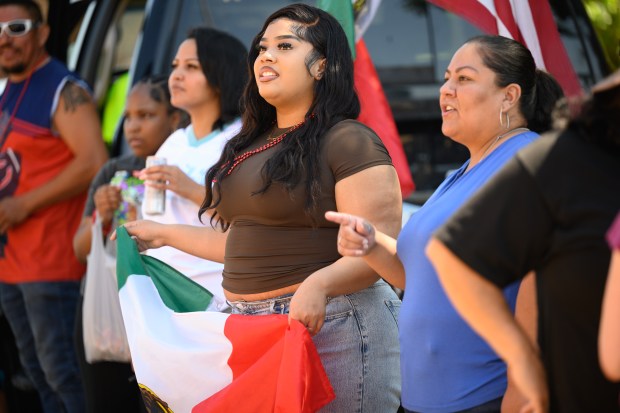 East Chicago resident Amara Alcazar, 17, holds up a Mexican flag as she celebrates during the 101st annual Fiestas Patrias parade on Sunday, Sept. 14, 2025. (Kyle Telechan/for the Post-Tribune)
