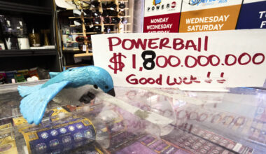 A sign reads "Powerball $1,800,000,000 Good Luck!" at the Bluebird Liquor store in Hawthorne, Calif...
