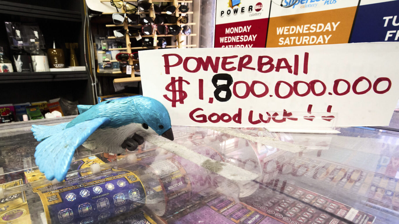 A sign reads "Powerball $1,800,000,000 Good Luck!" at the Bluebird Liquor store in Hawthorne, Calif...