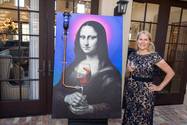 Kim Wagner with artwork from the Ethan Blu Transcendent Art...