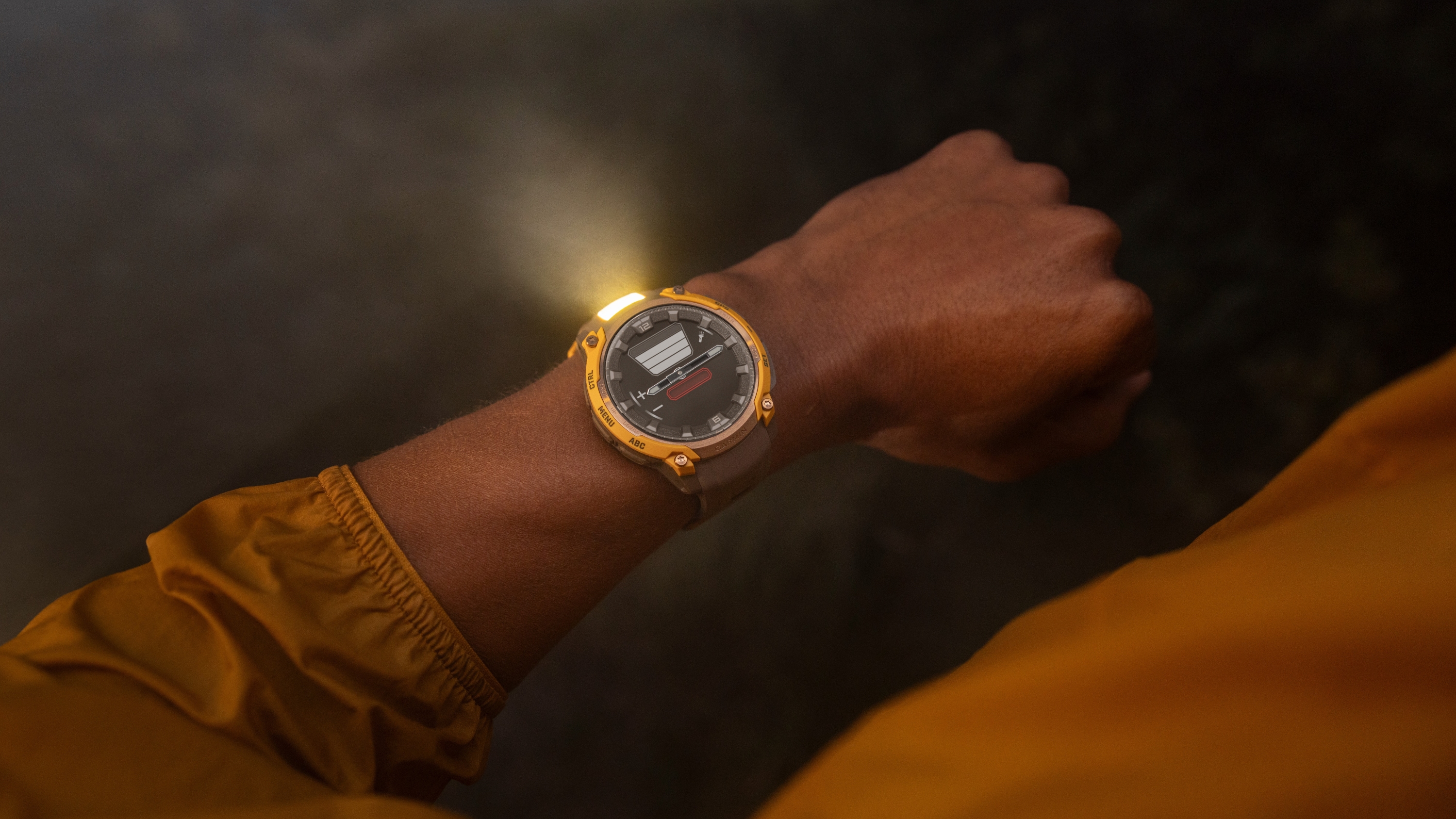 A photo of the Garmin Instinct Crossover AMOLED watch with the flashlight active on a person's wrist at night