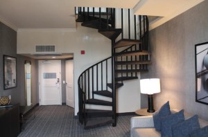 A spiral staircase in the middle of a hotel room.