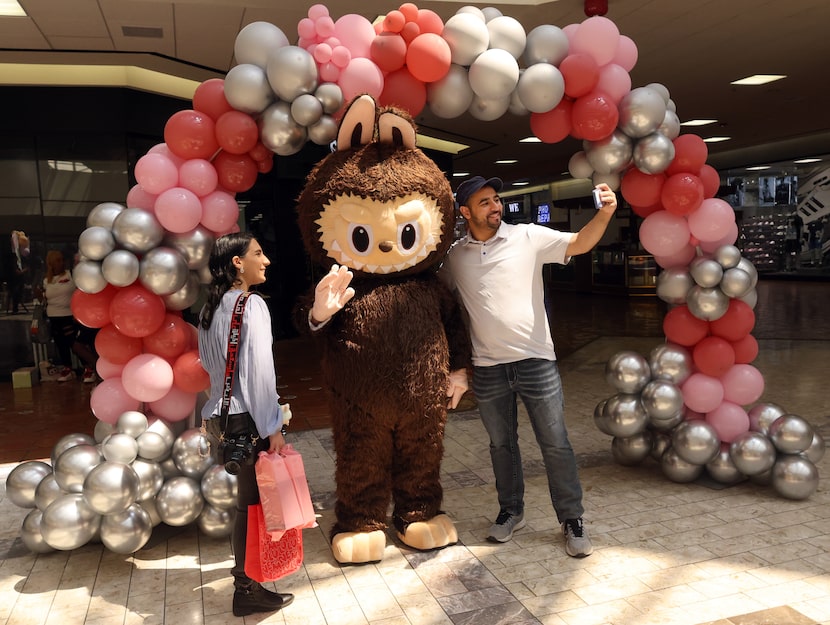 Aladeen Alhayek, right, takes a photo on his smartphone of himself and  Amira Alhayek as...