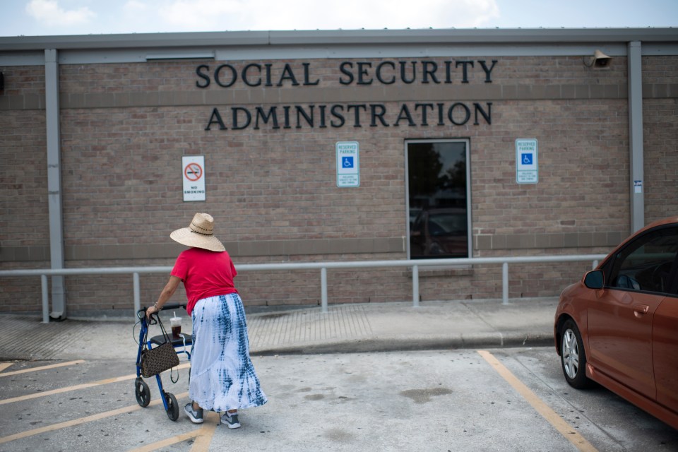 Woman with walker approaching Social Security Administration building.