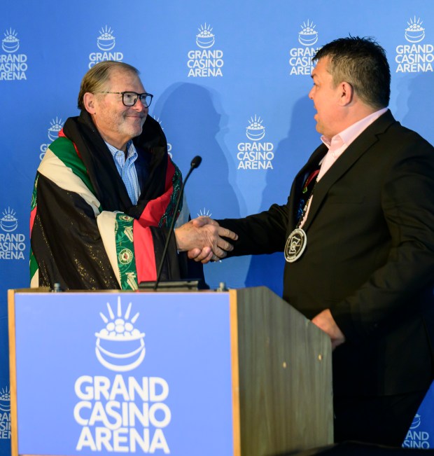 Minnesota Wild owner Craig Leipold, left, shakes hands with Virgil Wind, the chief executive of the Mille Lacs Band of Ojibwe.