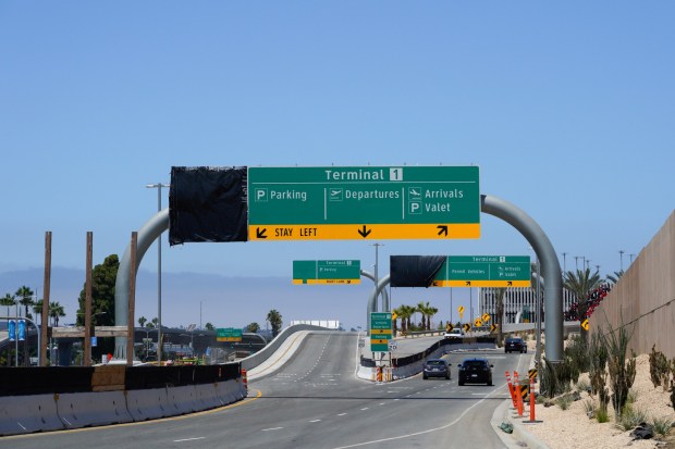 The first lane of the new airport road (on the left) directs you to Terminal 2, while the second and third lanes lead to Terminal 1 at San Diego International Airport. The large electronic signs will display the airlines along with the terminals from which they are operating. (Nelvin C. Cepeda / The San Diego Union-Tribune)