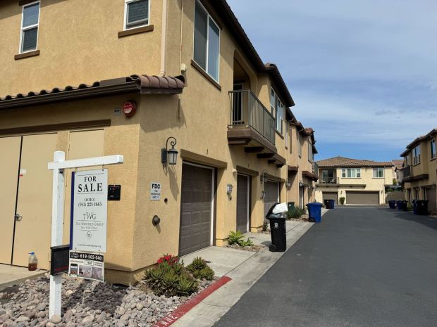 A for sale sign outside a row of townhouses in the Otay Ranch area of Chula Vista in mid-Sept.. (Phillip Molnar/The San Diego Union-Tribune)