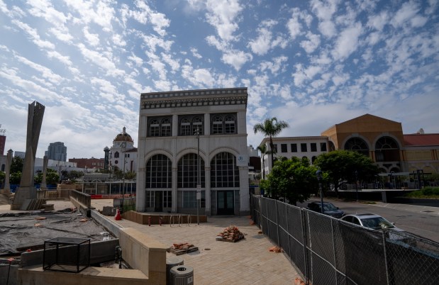 A view of the Bradley Building and Horton Plaza Park as seen from behind fences on Aug. 26, 2025. The former Macy's store is pictured in the background. (Ana Ramirez / The San Diego Union-Tribune)