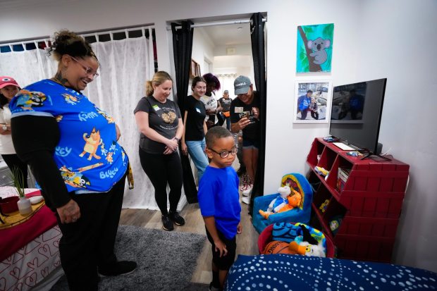 La Mesa, CA - August 15: Heather Moore, 33, and her 5-year-old son, King Moore, take a look at his new bed and toy box. The design team from Humble Design and volunteers are working on the makeover of Heather Moore's apartment in La Mesa, CA.  (Nelvin C. Cepeda / The San Diego Union-Tribune)