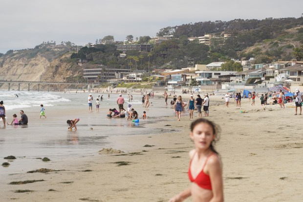 People have fun at the La Jolla Shores Beach in early July. (Michael Ho / The San Diego Union-Tribune)