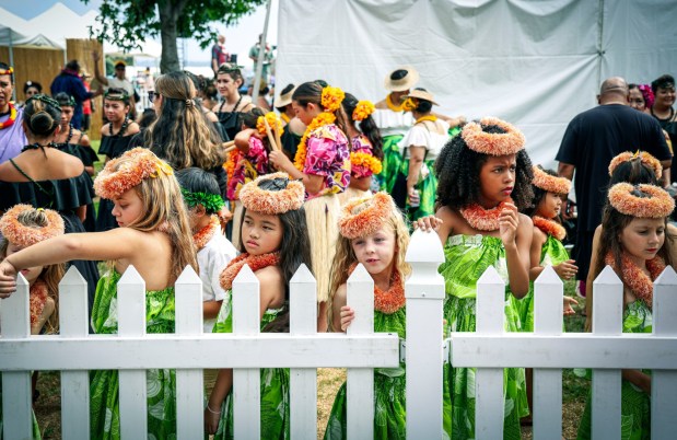 Members of the Keiki (Kids) dance group from the Huhai Halau O Ilima Pa Olapa Kahiko Dance Group prepares to perform during the Pacific Islander Festival at Ski Beach on Mission Bay on Saturday, Sept. 2025. The festival featrured foodbooths, atras and craftes booths and performers form several Pacific Island Nations. ( Photo by Sandy Huffaker for The San Diego Union-Tribune)