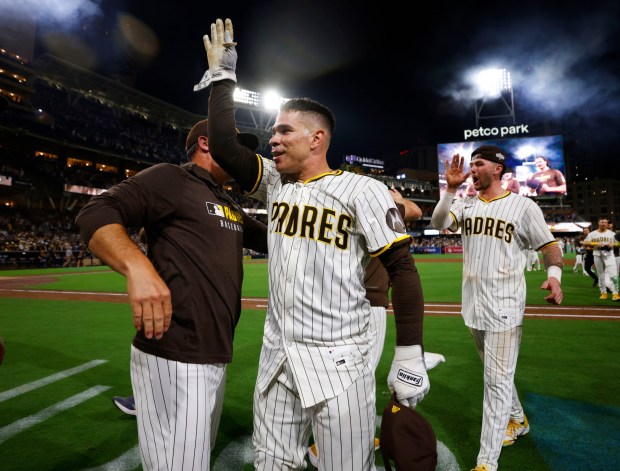 Freddy Fermin #54 of the San Diego Padres and.Jackson Merrill #3 celebrate after a walk-off win in the eleventh inning to beat the Milwaukee Brewers at Petco Park on Sept. 22, 2025 in San Diego, CA. (K.C. Alfred / The San Diego Union-Tribune)