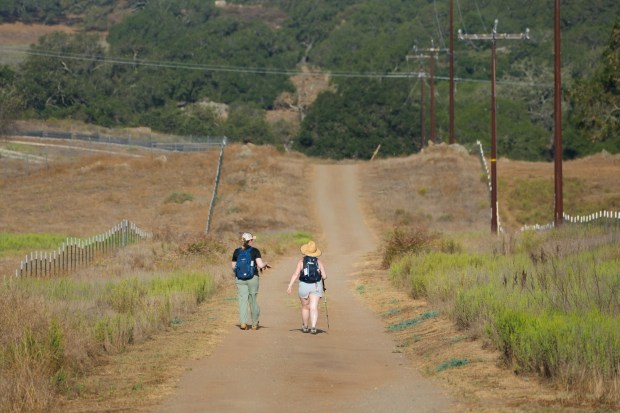 Randi Baldwin, left, of El Cajon and Jen Janzer were among the first hikers to set out on the Ramona Grasslands Old Survey Road 97 Trail on Saturday, Aug. 23, 2025. (Nelvin C. Cepeda / The San Diego Union-Tribune)