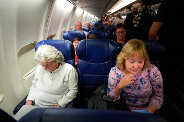Deborah McCarthy (l) and Aileen Dwyer (r) are among the passengers onboard Southwest Airlines flight 4298, the first group to arrive at the new Terminal 1 of San Diego International Airport. (Nelvin C. Cepeda / The San Diego Union-Tribune)