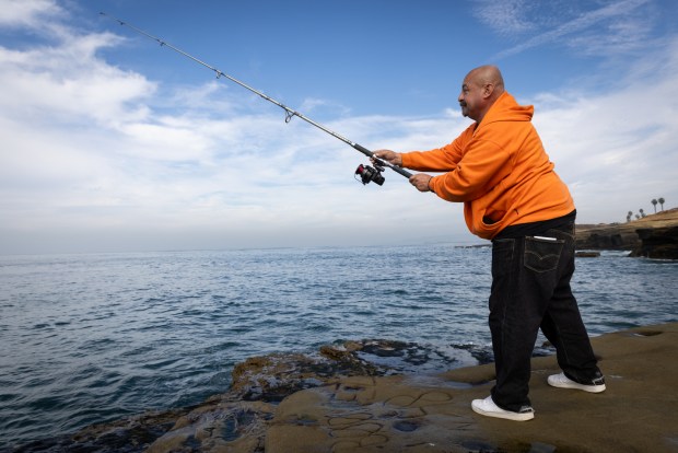 David Rodriguez, 55, of Chula Vista fishes at Sunset Cliffs with his brother on Friday, Jan. 3, 2025 in San Diego. (Ana Ramirez / The San Diego Union-Tribune)