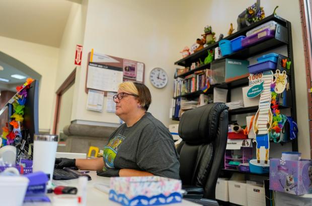 Maureen Meadows, youth services librarian, works at her desk at the Rancho Peñasquitos library on Wednesday, Sept. 3, 2025. (Alejandro Tamayo / The San Diego Union-Tribune)