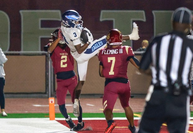 Prep Football- Granite Hills at Mission Hills-  Granite Hill receiver Rocket Demery makes a catch of a pass from QB Zachark Benitez but it was called out of bounds. Mission Hills defenders are #2 Xavier St. John and #7 Patrick Fleming. (Charlie Neuman / For The San Diego Union-Tribune)