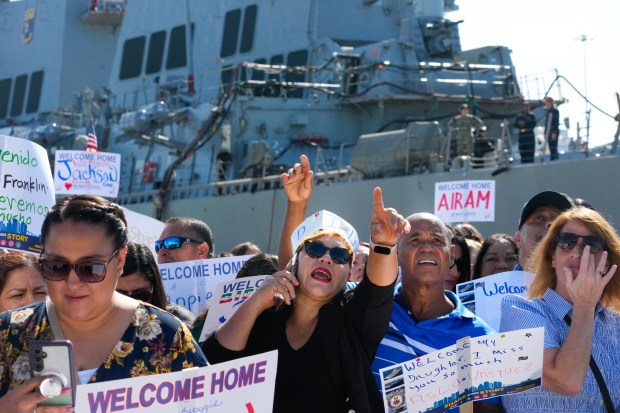 On Thursday, Sept. 25, 2025, Delladeris Perez and Frankie Cornelio searched to spot their sailor, Aslid Vasquez. The couple were among several family and friends who waved to their sailors on board the USS America (LHA 6) as she pulled into Naval Base San Diego. After serving in Japan as her homeport for the past six years, the USS America will now be based in San Diego.  (Nelvin C. Cepeda / The San Diego Union-Tribune)