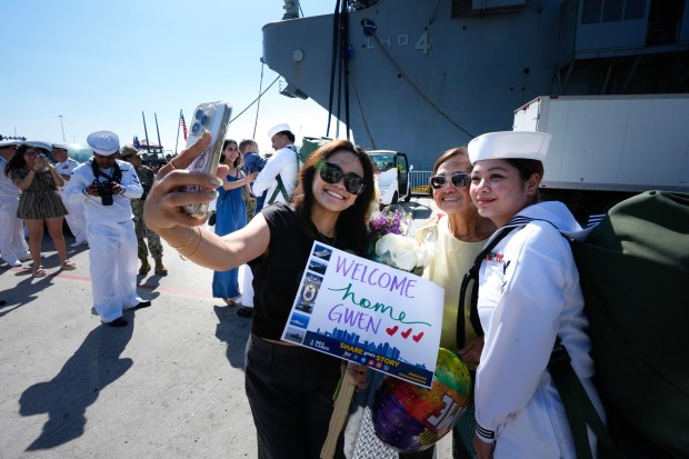 Tamil Dimitui, along with her mother, Judi Dimitui of Paradise Hills, took a selfie photo with her sister, Gwen Salazar, who was on board the USS America (LHA 6). After serving in Japan as her homeport for the past six years, the USS America will now be based in San Diego.    (Nelvin C. Cepeda / The San Diego Union-Tribune)