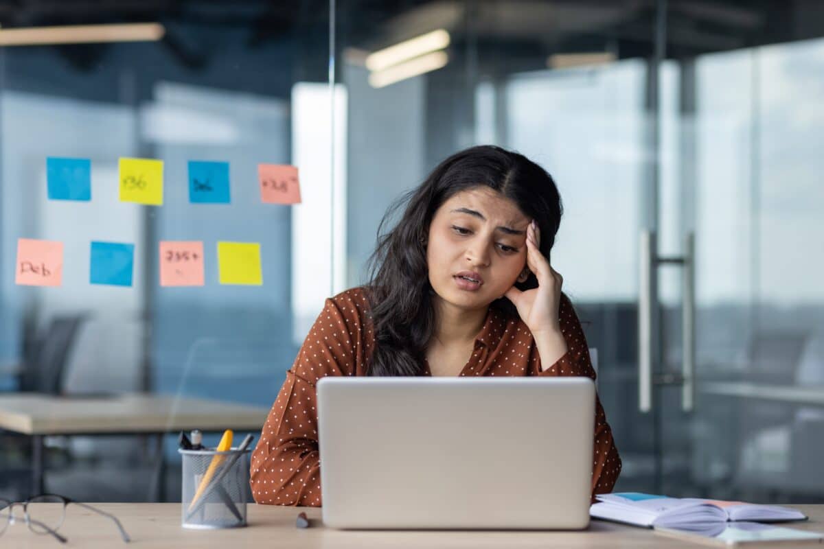 Sad, upset woman stressed at her work desk