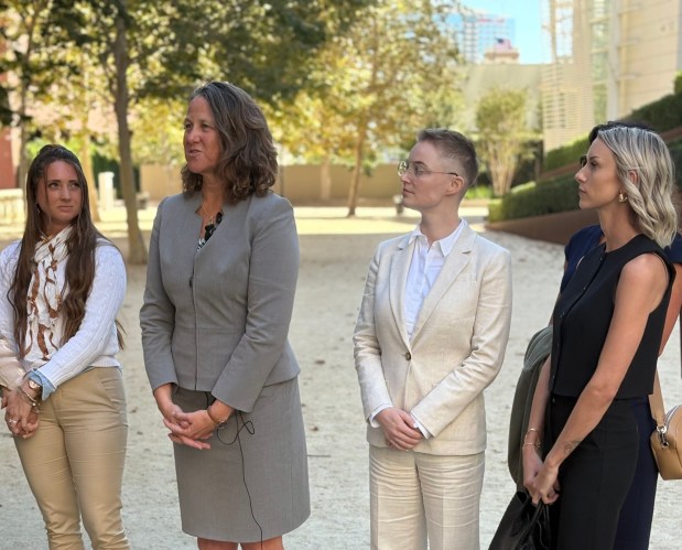 Flanked by survivors, Assistant U.S. Attorney Sasha Foster speaks to reporters Monday outside the downtown San Diego federal courthouse following the sentencing of former GirlsDoPorn owner and operator Michael James Pratt. (Alex Riggins/The San Diego Union-Tribune)