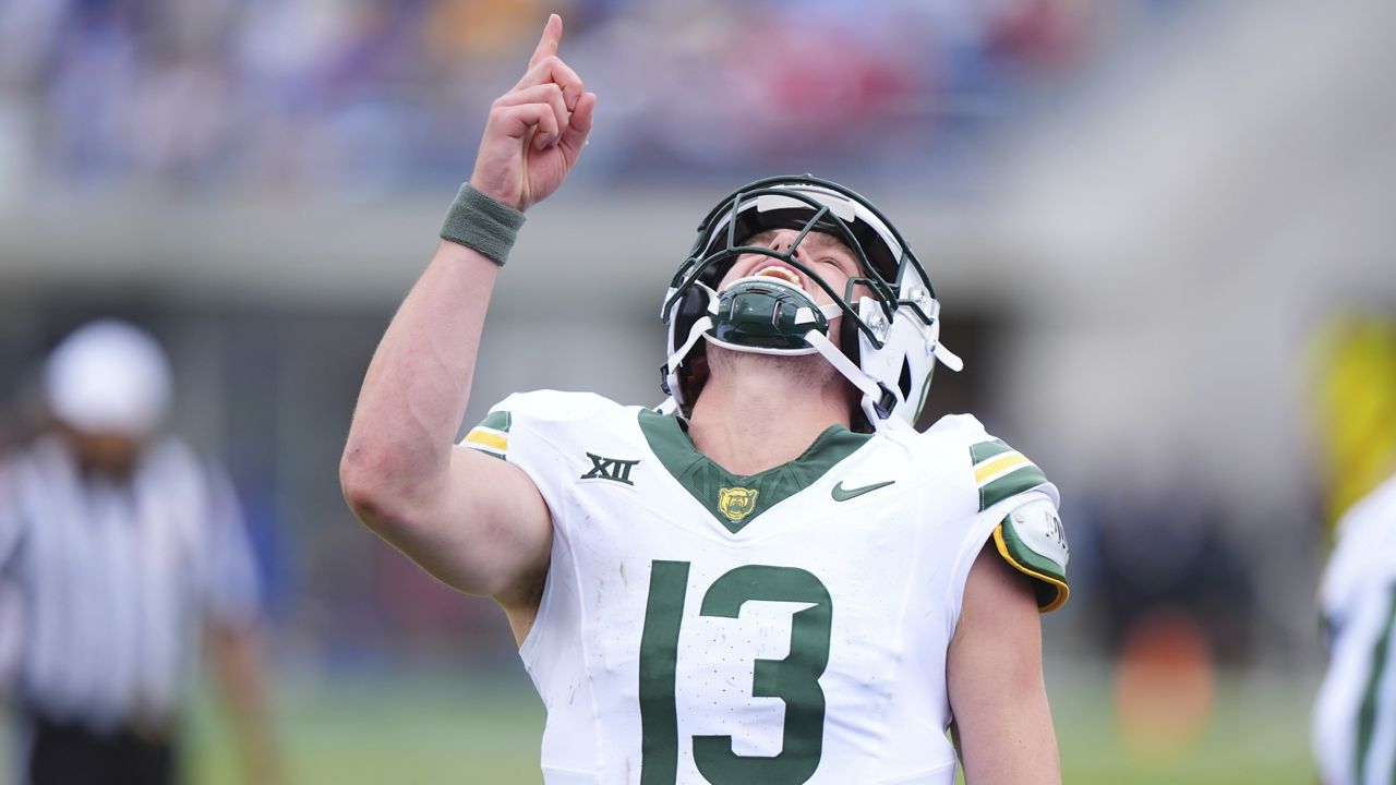 Baylor quarterback Sawyer Robertson (13) reacts to throwing a touchdown pass during the second half of an NCAA college football game against SMU Saturday, Sept. 6, 2025, in Dallas. (AP Photo/LM Otero)