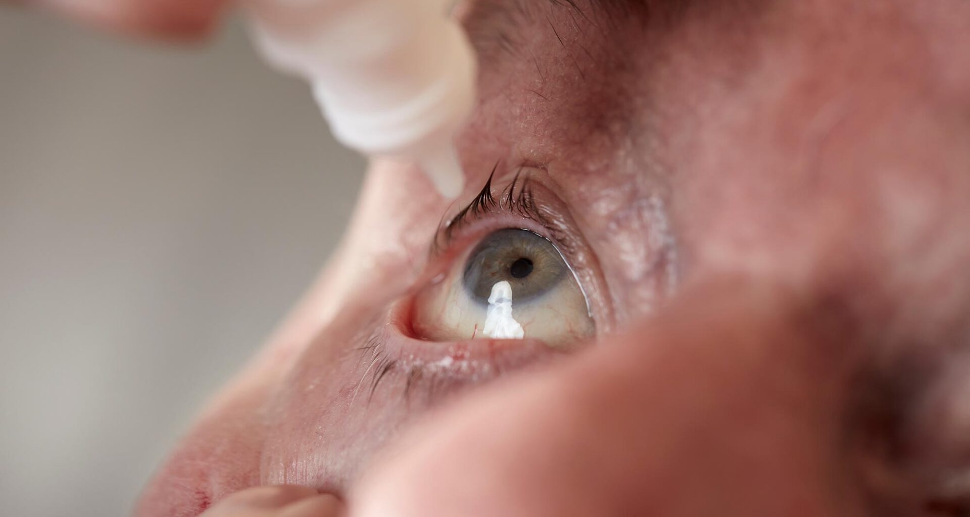 Senior Man Eye Drops Close Up