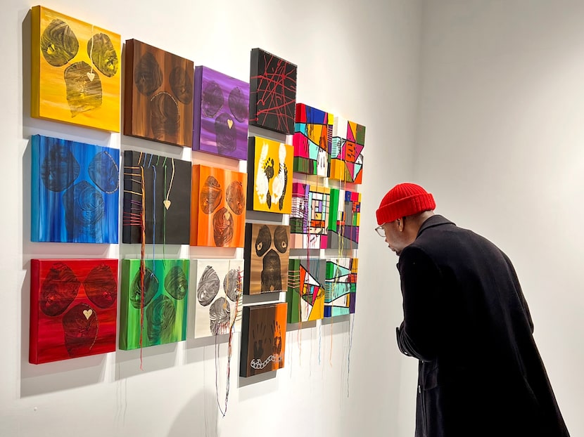 A visitor examined the artwork at the opening of the "Jennifer Monet Cowley: Patchwork"...