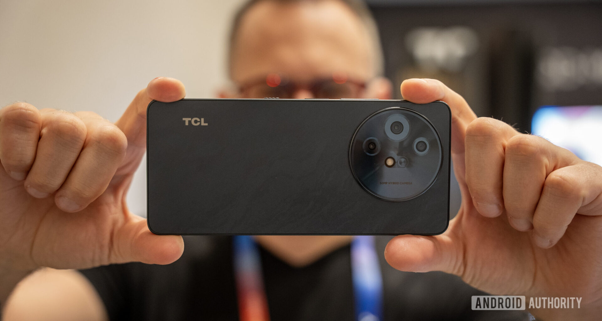 TCL 60 XE NXTPAPER 5G held horizontally for a photo
