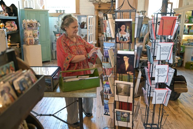 5 Green Boxes owner Charlotte Elich sorts postcards on a rack at the boutique in Denver on Thursday, Sept. 4, 2025. (Photo by Hyoung Chang/The Denver Post)