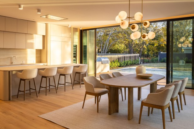 Wall-to-wall sliding glass doors allow the living space to flood...