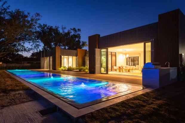 The backyard is highlighted by a 100-foot-long all marble swimming...