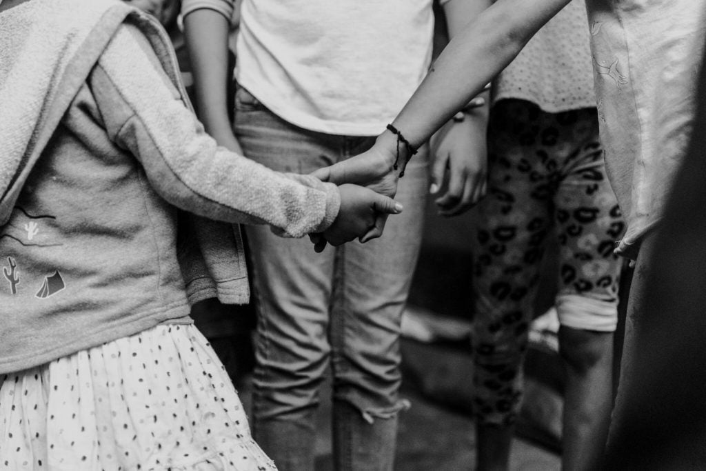 A kid and her mother holding hands while being aided by San Diego nonprofit This is About Humanity