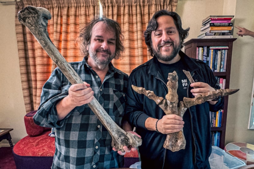 Filmmaker Peter Jackson, left, and Colossal CEO Ben Lamm hold up bones from Jackson's...