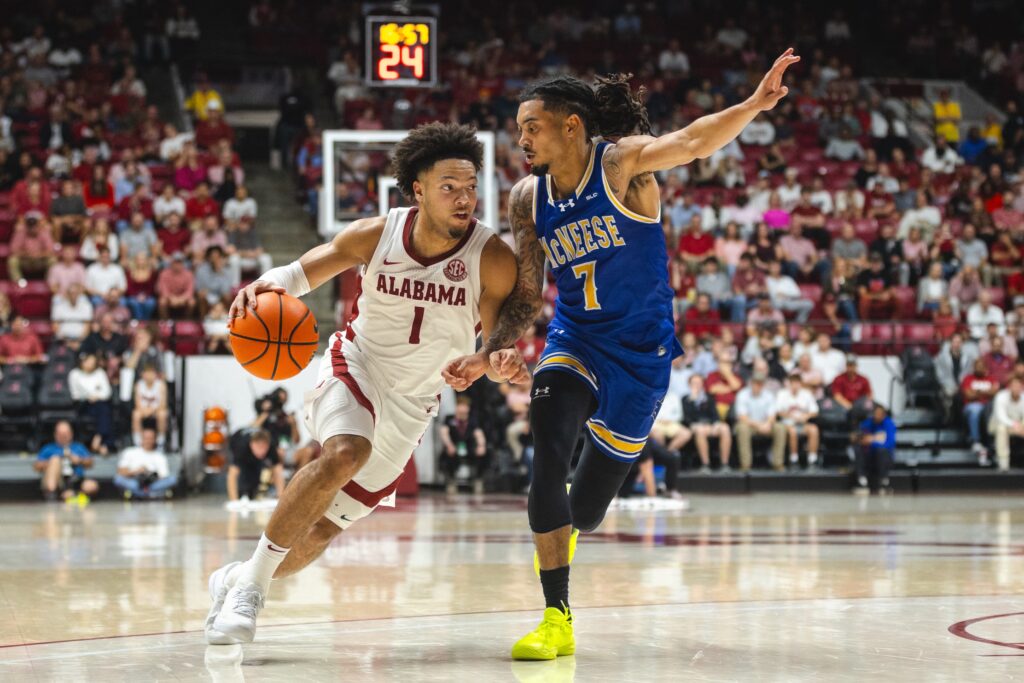 Nov 11, 2024; Tuscaloosa, Alabama, USA; Alabama Crimson Tide guard Mark Sears (1) drives the ball against McNeese State Cowboys guard Alyn Breed (7) during the second half at Coleman Coliseum. Mandatory Credit: Will McLelland-Imagn Images