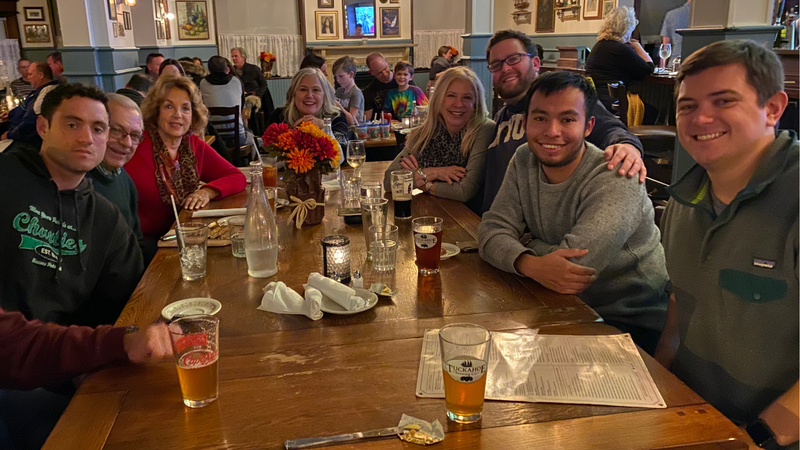 Jason and Henry with family at a restaurant 