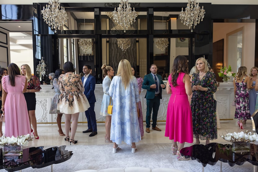 Guests chat at a Preston Hollow home hosting a High Tea with Sarah Ferguson, Duchess of York.