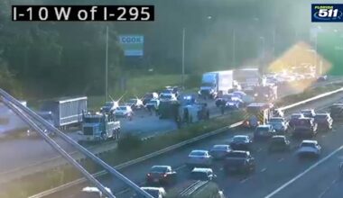 Back-ups building after dump truck overturns on I-10 west of I-295