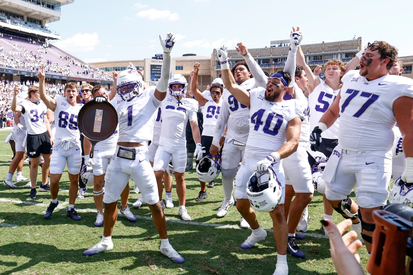 TCU players celebrate with the skillet after winning an NCAA football game against SMU,...