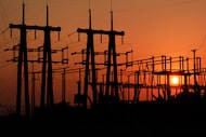 The sun sets behind a Brazos Electric Power Cooperative substation near Rhome, Texas, on...