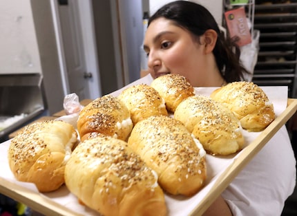 Barista Ashley Gomez delivers a tray of baked goods fresh from the kitchen oven at PanPan...