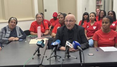PFT president Arthur Steinberg (in black) and chief of staff LeShawna Coleman (to his right) discuss the union's contract, ratified by members Thursday night.