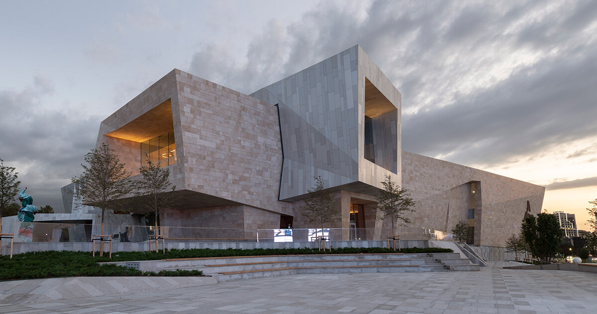 kazakhstan's almaty museum of arts completes as pair of stone and aluminum volumes