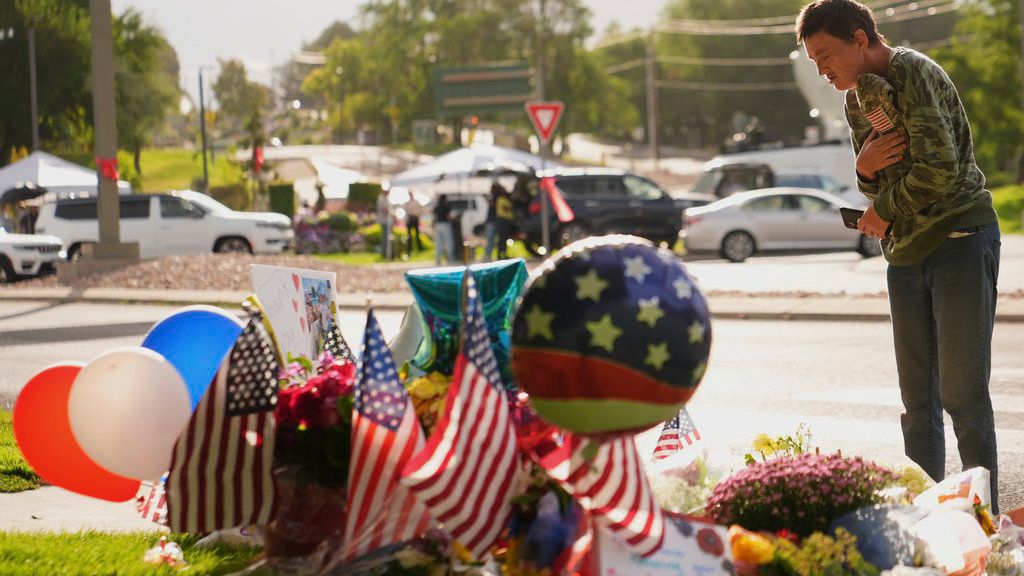 Wendy Lucas, a Utah Valley University student, looks at a memorial set up for Charlie Kirk at Utah Valley University in Orem, Utah, Friday, Sept. 12, 2025. (AP Photo/Lindsey Wasson)
