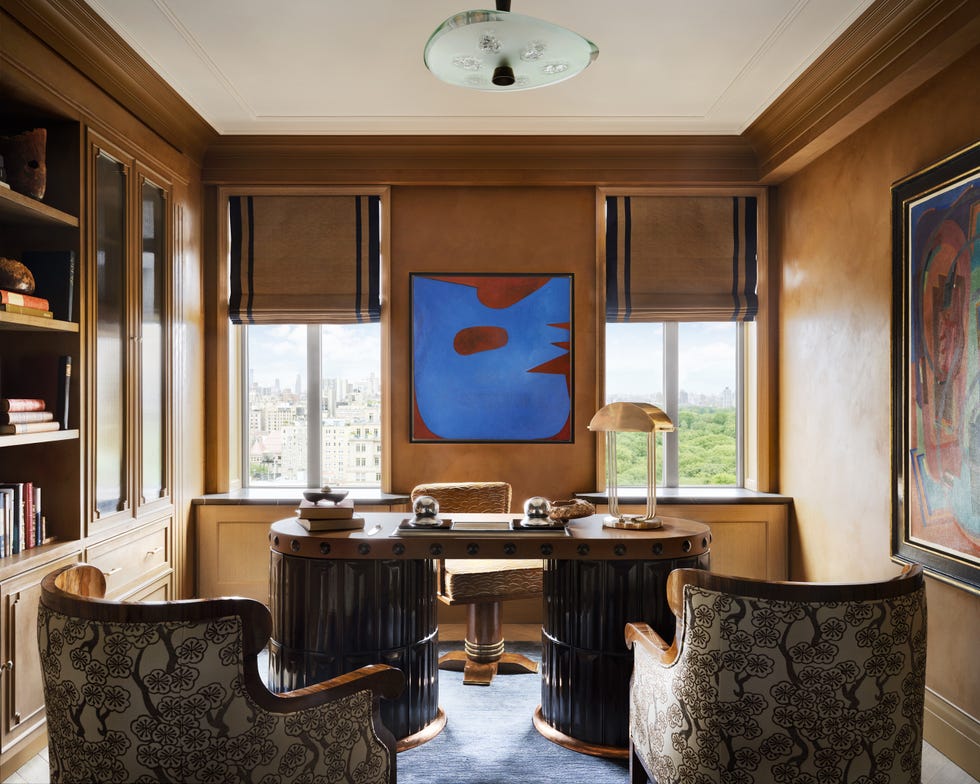 Cozy home office space with artistic elements and city views.